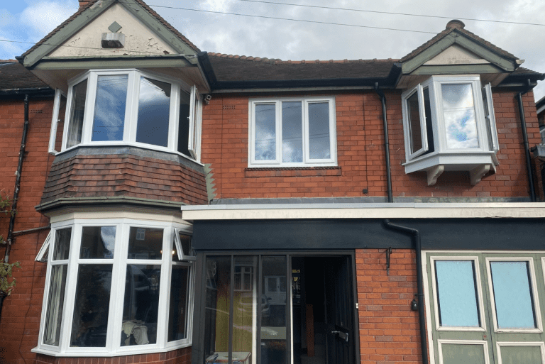 Exterior view of Bearwood home after bay window and casement window installation.
